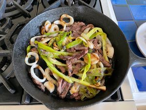 meat  onions heating in a cast-iron skillet