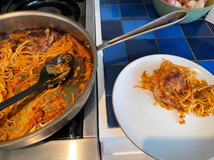 Pan and a plate both with pasta