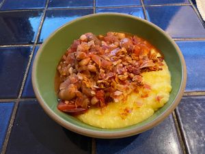Bowl of polenta with tomato and beans