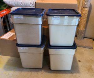 4 large platic tubs each containing 25lb of flour in a basement