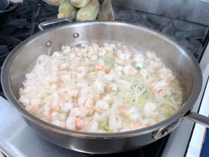 shrimp sauteeing in a large pan
