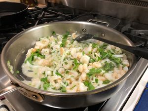 shrimp cooking in a large sauté pan