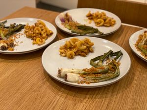 Spring onions and pasta on plates