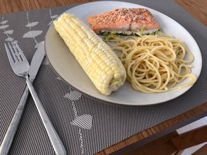 salmon, pasta, corn on a plate