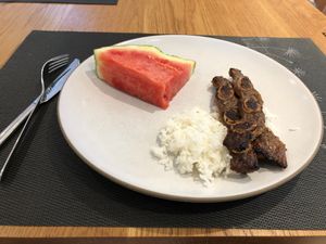 watermelon, rice and a rib on a plate
