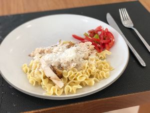 a plate with pasta and tomatoes