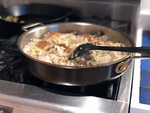 chicken and rice cooking in a pan