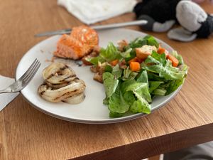 Plate with salmon, BBQ onions, and green salad