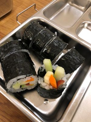 Sushi rolls in a metal lunch box