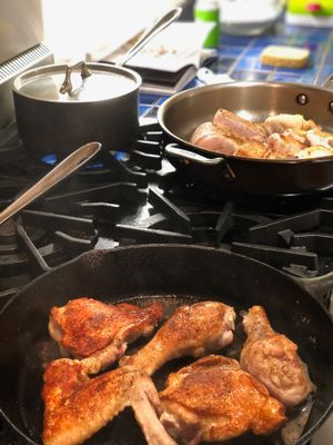 Chicken browning in two pans