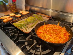 Tomato-bean bake, asparagus, and grilled bread on the range
