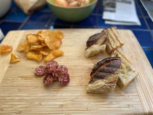 Grilled bread and sliced salami chunks