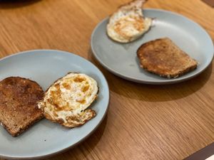 Fried eggs and toast on plates