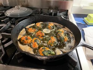Chicken meatballs cooking on stove