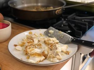 A pile of flaked fish on a plate