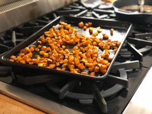 Roasted cubes of squash in the pan