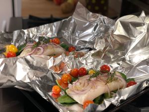 Raw fish about to be enclosed in foil packets