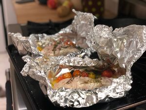 Fish just cooked, still in foil packets